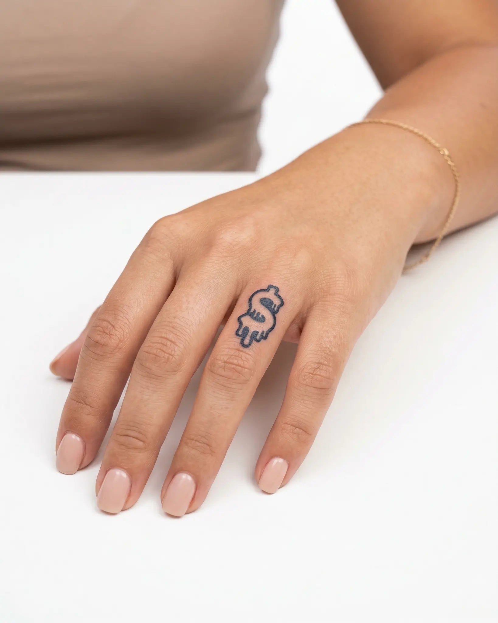 INKY Drip Money semi-permanent tattoo applied on a woman – 0.5 x 0.5 in (1x1 cm) design, realistic ink look, lasts 10 days