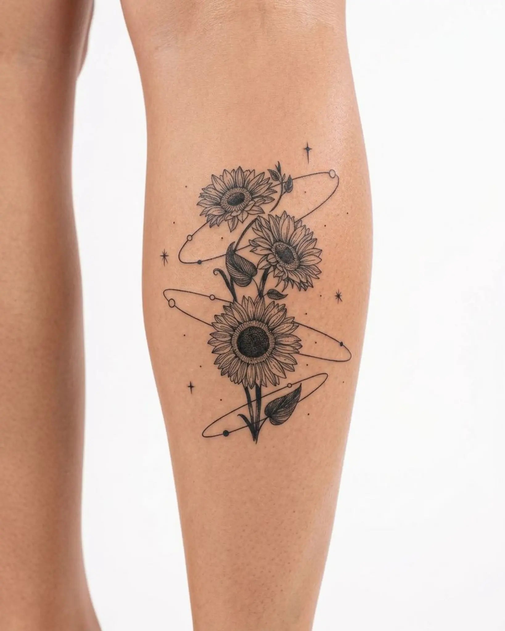 INKY Sunflower Orb 2 semi-permanent tattoo applied on a woman – 2 x 4 in (6x10 cm) design, realistic ink look, lasts 10 days