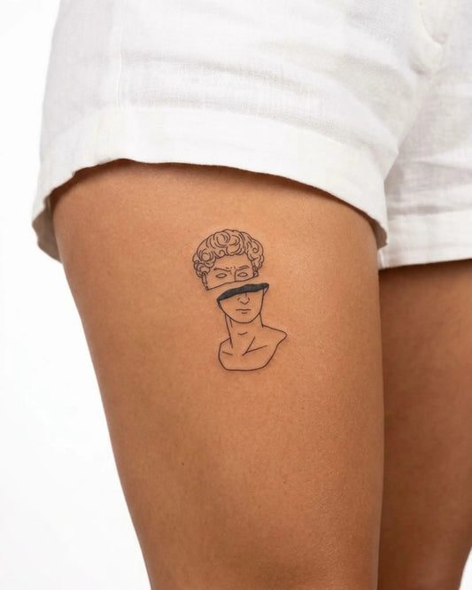 INKY Split Statue semi-permanent tattoo applied on a woman – 3 x 4 in (7x10 cm) design, realistic ink look, lasts 10 days