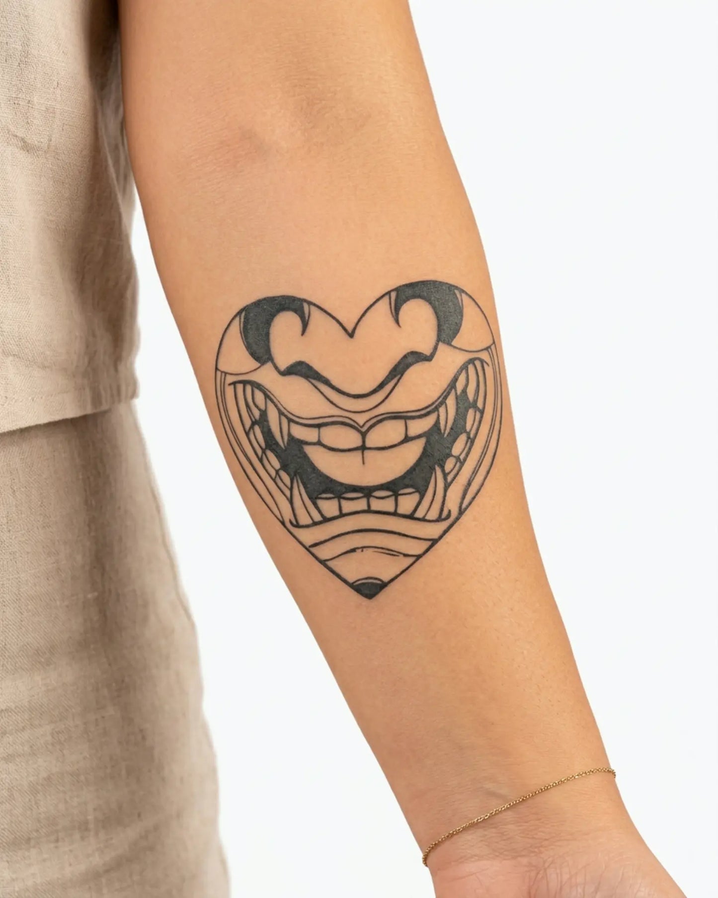 INKY Fanged Heart semi-permanent tattoo applied on a woman – 3 x 3 in (7x7 cm) design, realistic ink look, lasts 10 days
