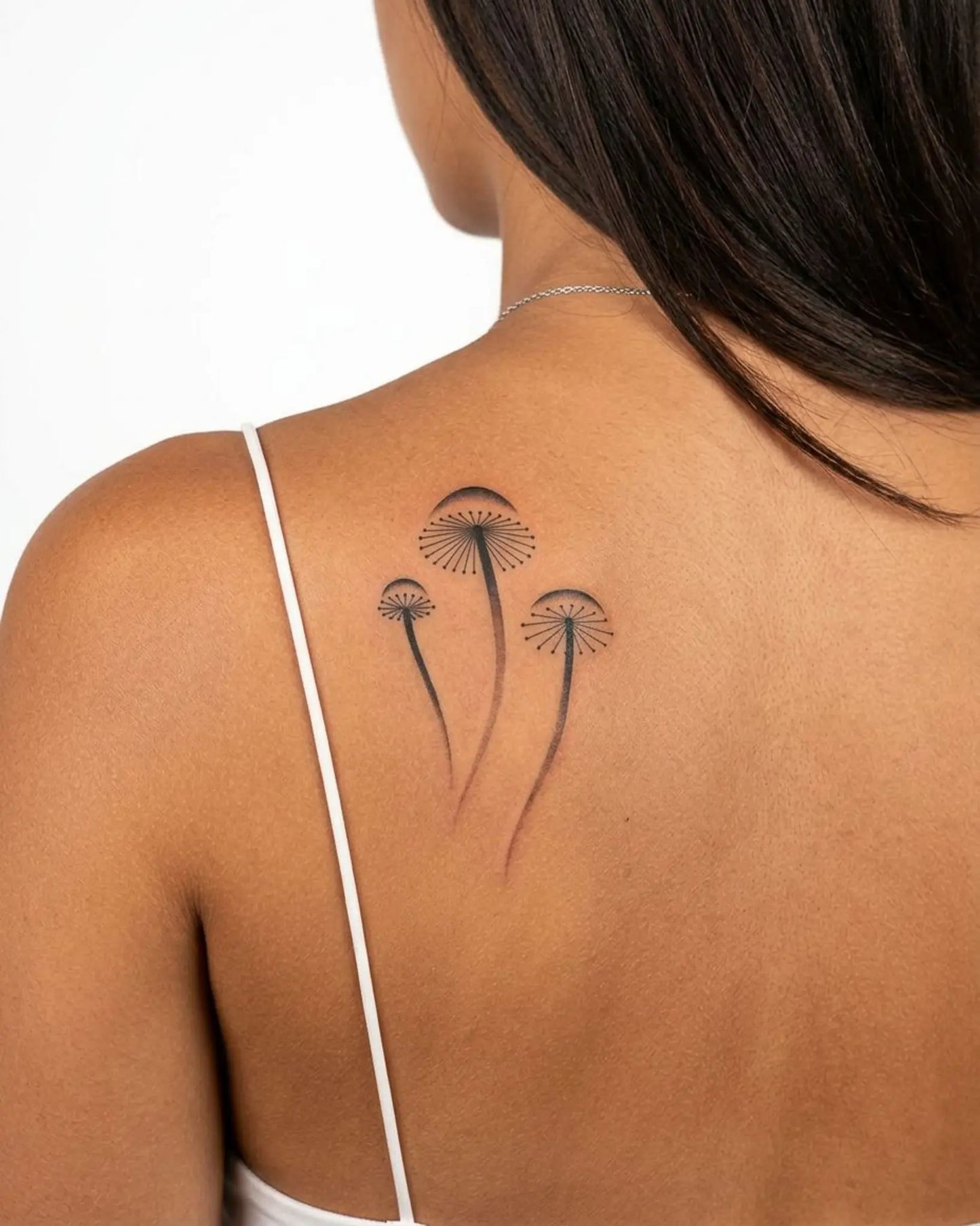 INKY Spore Bloom semi-permanent tattoo applied on a woman – 2 x 4 in (6x10 cm) design, realistic ink look, lasts 10 days