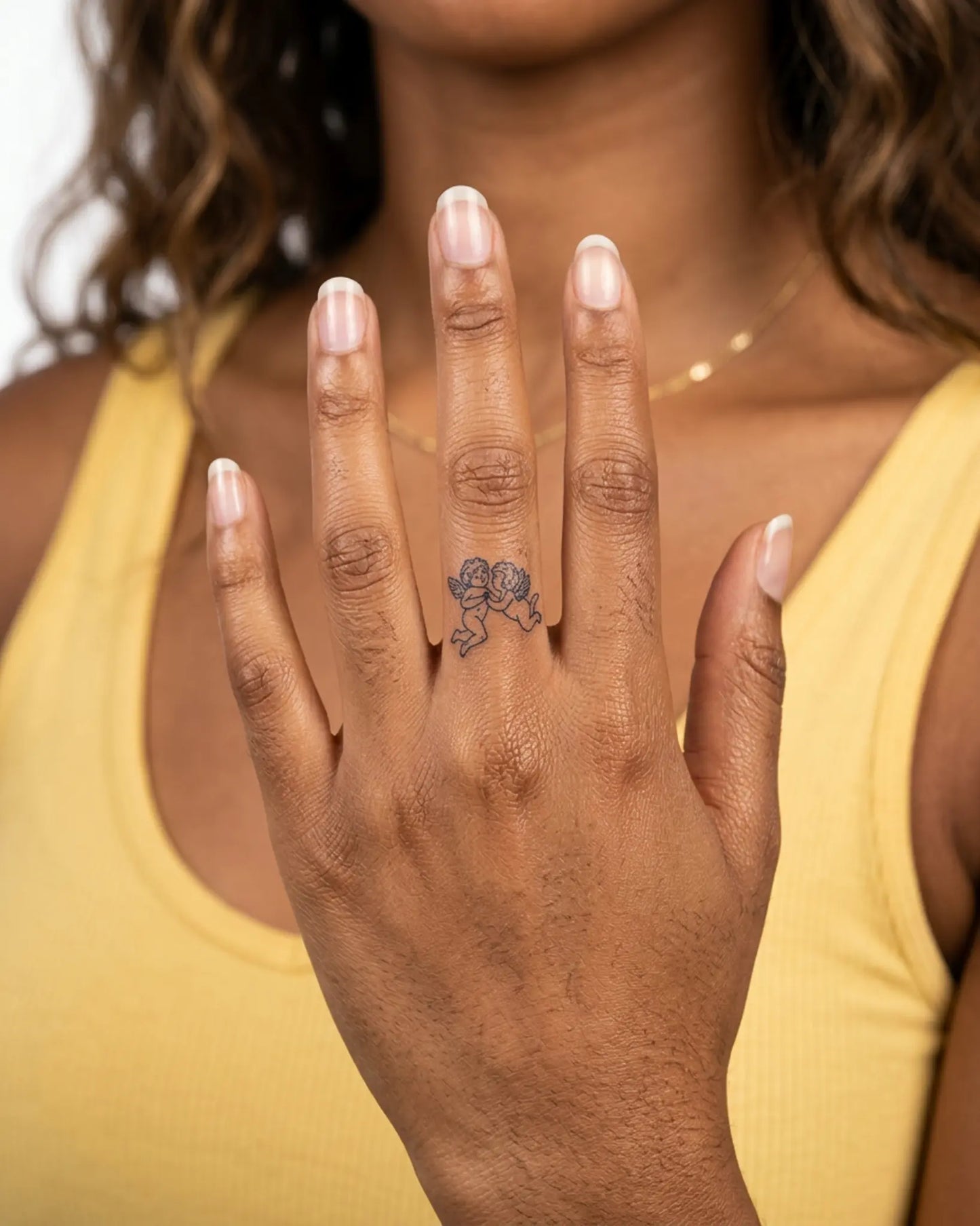 INKY Cherubs semi-permanent tattoo applied on a woman – 0.5 x 0.5 in (1x1 cm) design, realistic ink look, lasts 10 days
