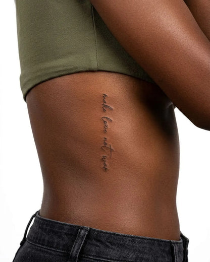 INKY Love Not War semi-permanent tattoo applied on a woman – 2 x 4 in (6x10 cm) design, realistic ink look, lasts 10 days
