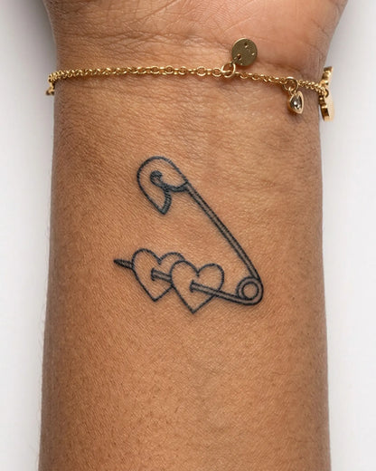 INKY Pinned Hearts semi-permanent tattoo applied on a woman – 2 x 2 in (4x4 cm) design, realistic ink look, lasts 10 days