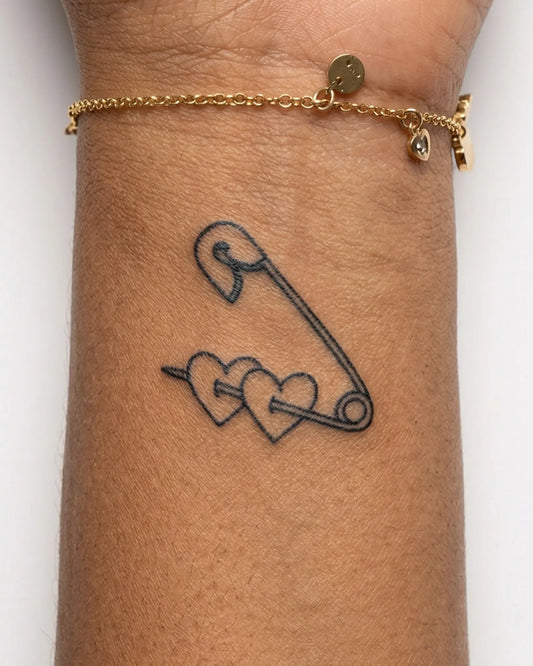 INKY Pinned Hearts semi-permanent tattoo applied on a woman – 2 x 2 in (4x4 cm) design, realistic ink look, lasts 10 days