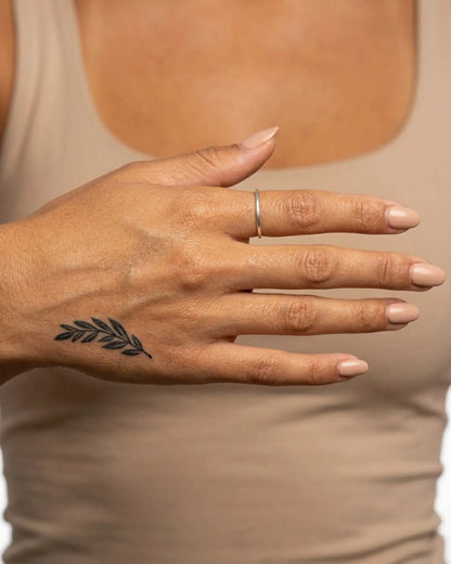 INKY Leafy Branch semi-permanent tattoo applied on a woman – 2 x 2 in (4x4 cm) design, realistic ink look, lasts 10 days