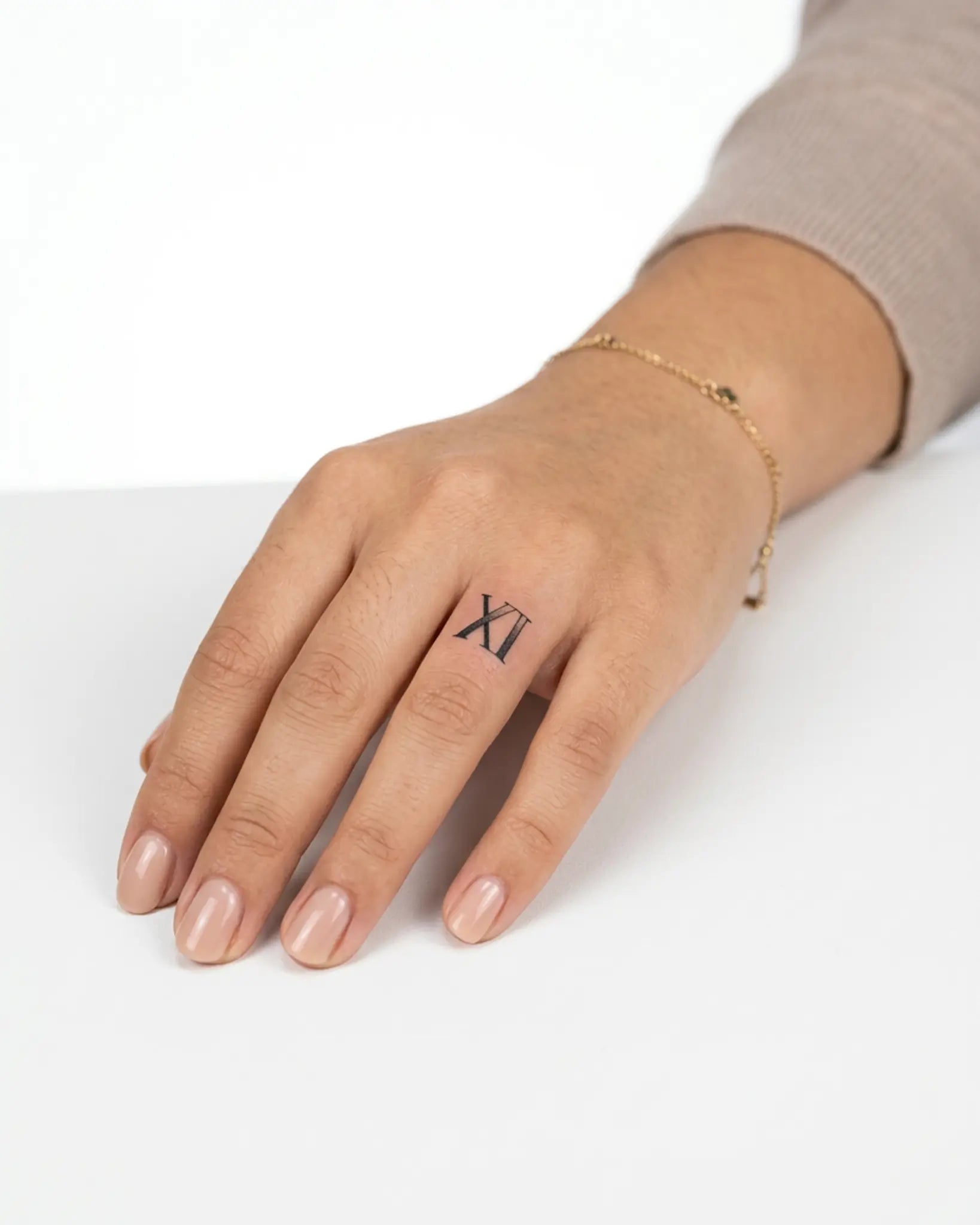 INKY XI Dotwork semi-permanent tattoo applied on a woman – 0.5 x 0.5 in (1x1 cm) design, realistic ink look, lasts 10 days
