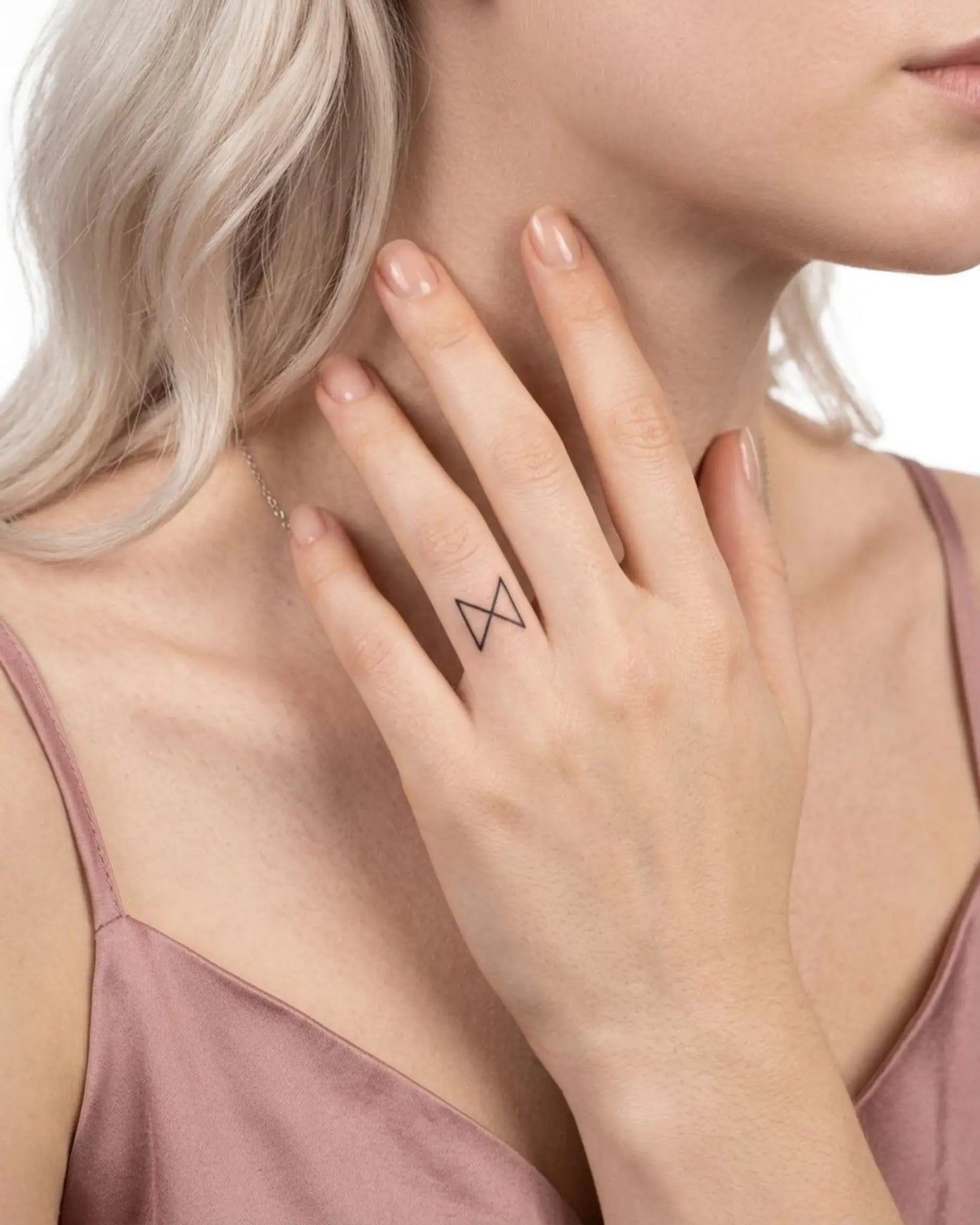 INKY Minimal X semi-permanent tattoo applied on a woman – 0.5 x 0.5 in (1x1 cm) design, realistic ink look, lasts 10 days