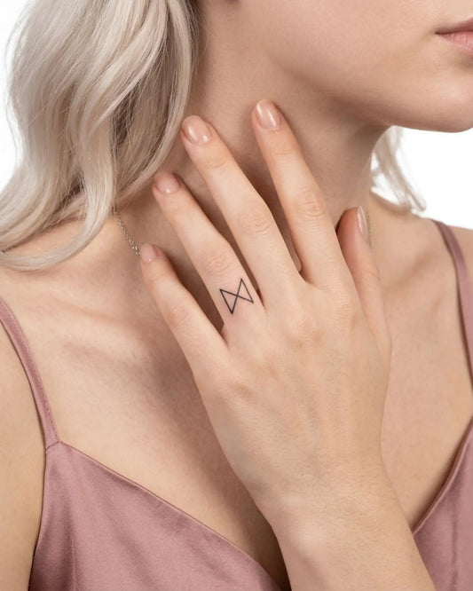 INKY Minimal X semi-permanent tattoo applied on a woman – 0.5 x 0.5 in (1x1 cm) design, realistic ink look, lasts 10 days