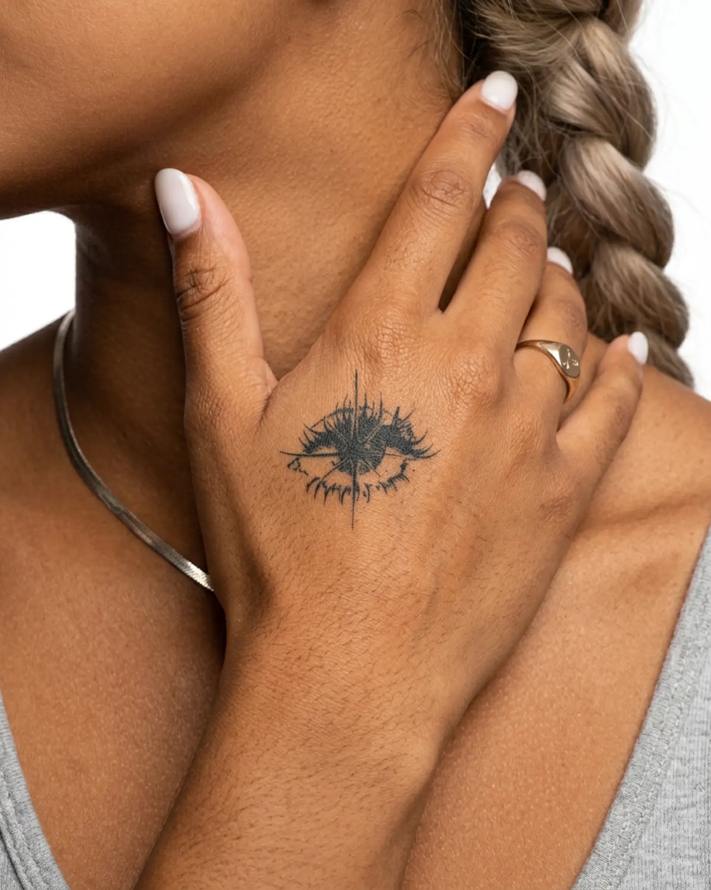INKY Dark Gaze semi-permanent tattoo applied on a woman – 2 x 2 in (4x4 cm) design, realistic ink look, lasts 10 days