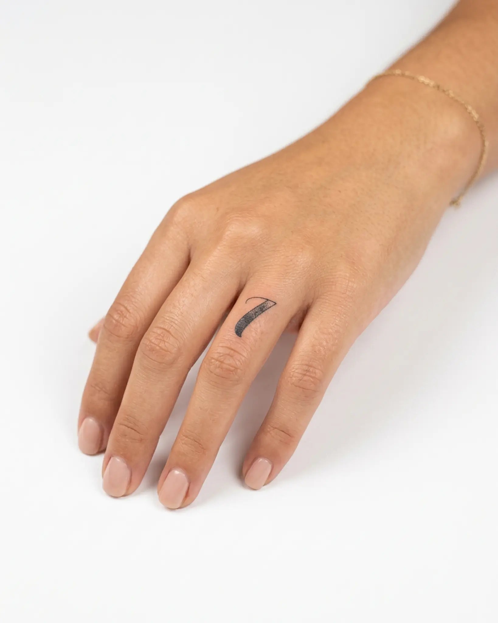 INKY Lucky Seven semi-permanent tattoo applied on a woman – 0.5 x 0.5 in (1x1 cm) design, realistic ink look, lasts 10 days