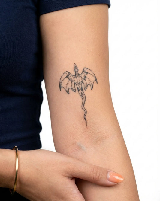INKY Draco Charm semi-permanent tattoo applied on a woman – 2 x 4 in (6x10 cm) design, realistic ink look, lasts 10 days