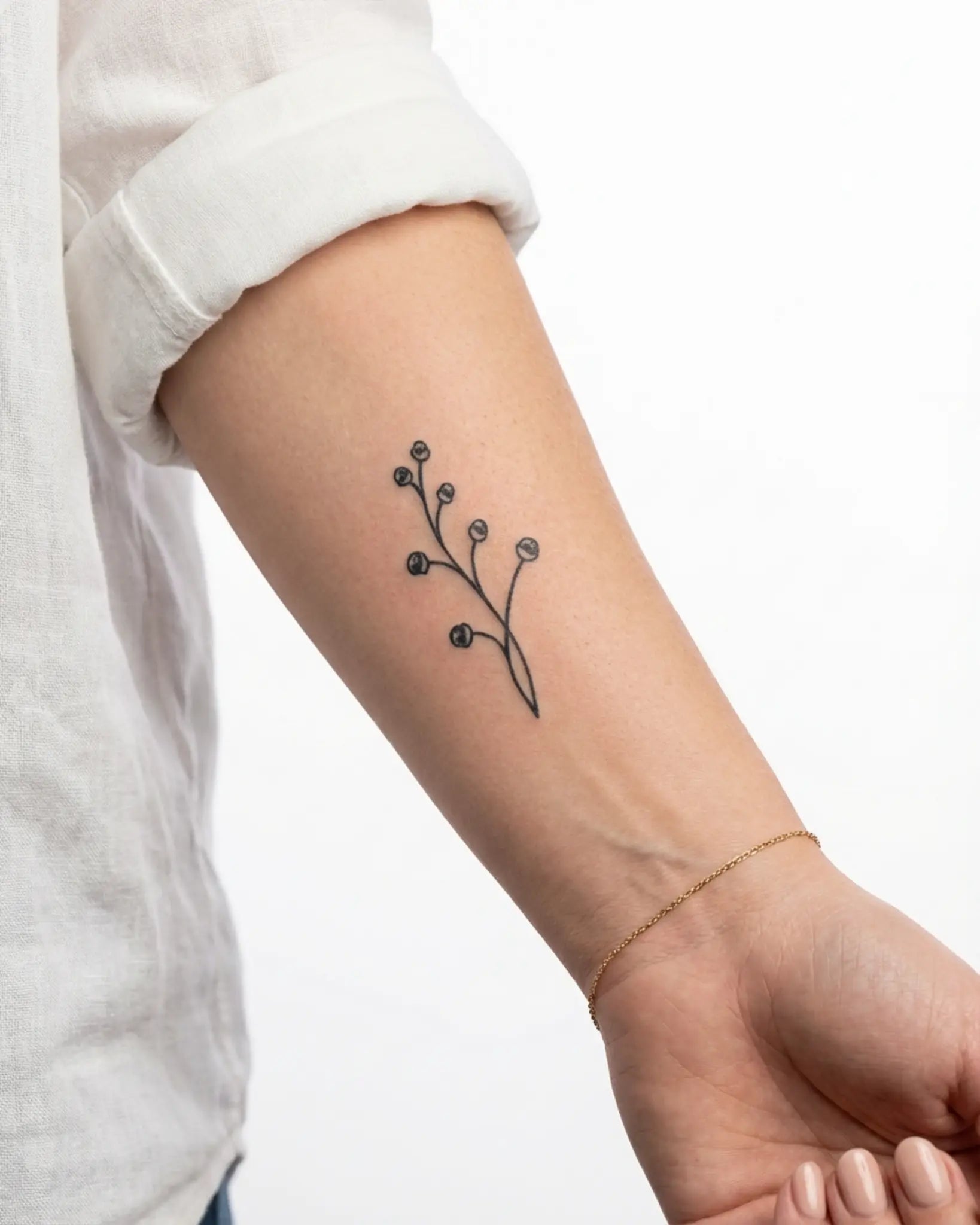 INKY Berry Stem semi-permanent tattoo applied on a woman – 2 x 4 in (6x10 cm) design, realistic ink look, lasts 10 days