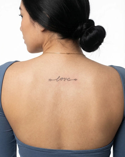 INKY Love Arrow 5 semi-permanent tattoo applied on a woman – 2 x 4 in (6x10 cm) design, realistic ink look, lasts 10 days