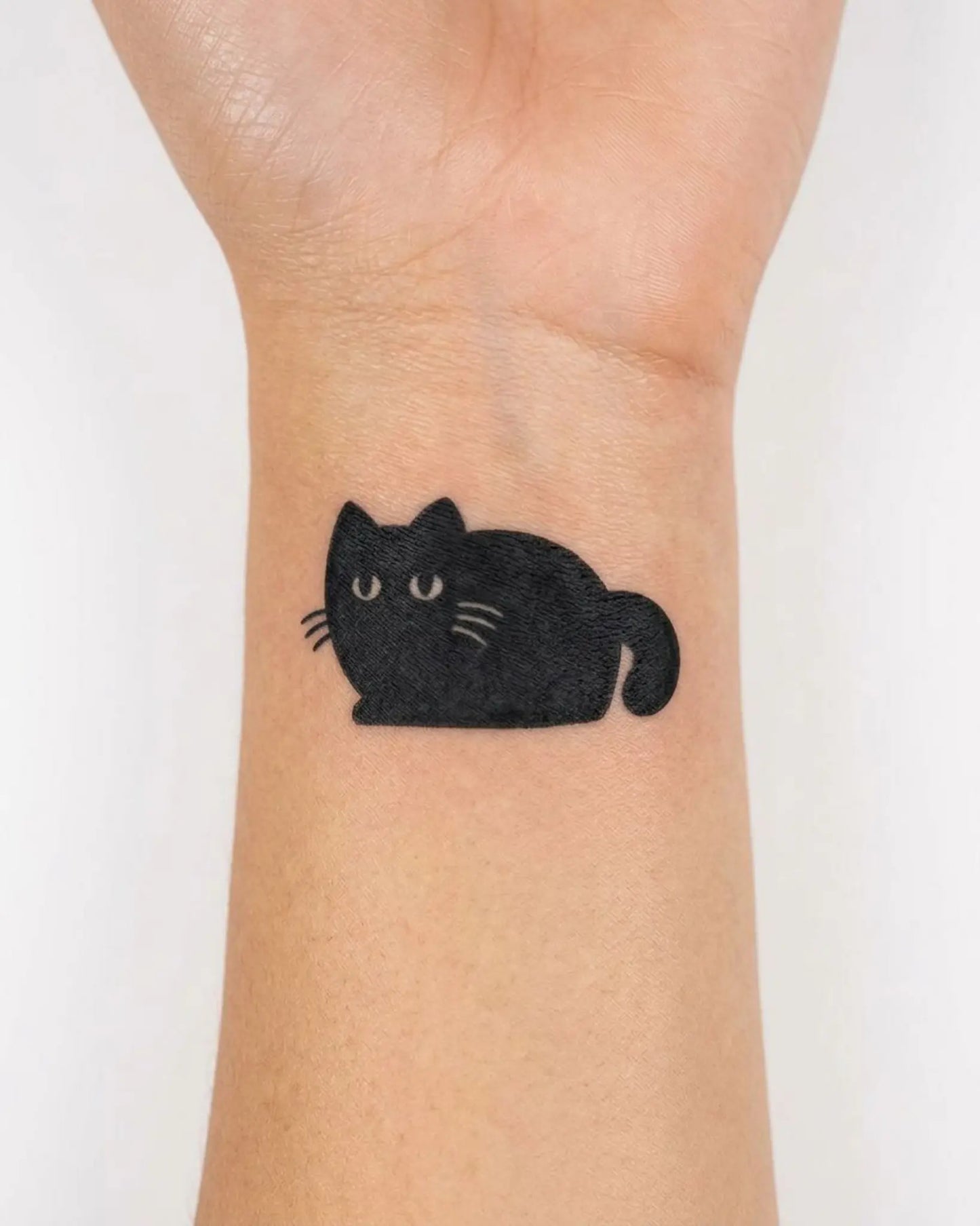 INKY Kitty Loaf semi-permanent tattoo applied on a woman – 2 x 2 in (4x4 cm) design, realistic ink look, lasts 10 days