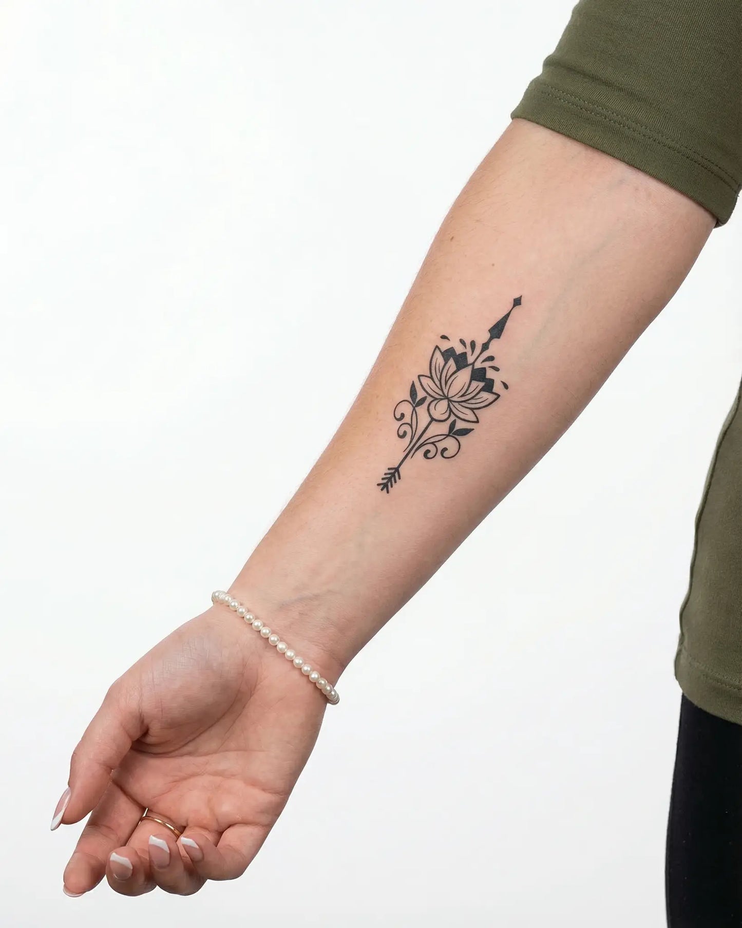 INKY Lotus Arrow semi-permanent tattoo applied on a woman – 2 x 4 in (6x10 cm) design, realistic ink look, lasts 10 days