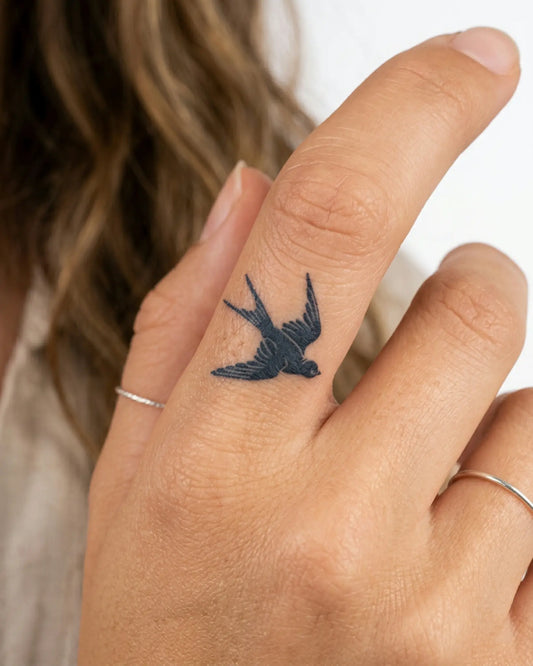 INKY Swallow semi-permanent tattoo applied on a woman – 0.5 x 0.5 in (1x1 cm) design, realistic ink look, lasts 10 days
