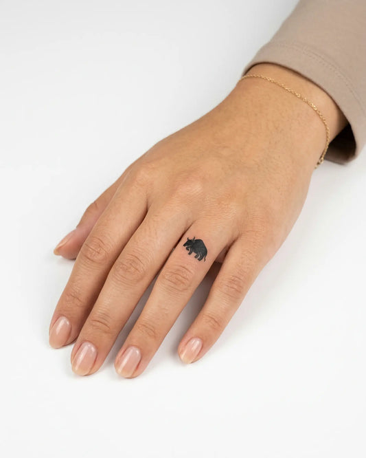 INKY Black Bull semi-permanent tattoo applied on a woman – 0.5 x 0.5 in (1x1 cm) design, realistic ink look, lasts 10 days