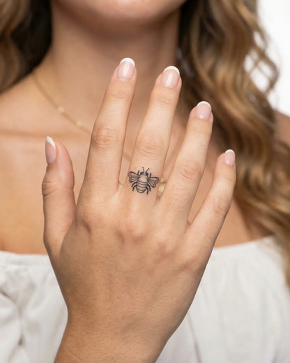 INKY Buzz Bee 2 semi-permanent tattoo applied on a woman – 0.5 x 0.5 in (1x1 cm) design, realistic ink look, lasts 10 days