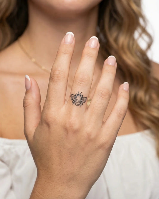 INKY Buzz Bee 2 semi-permanent tattoo applied on a woman – 0.5 x 0.5 in (1x1 cm) design, realistic ink look, lasts 10 days