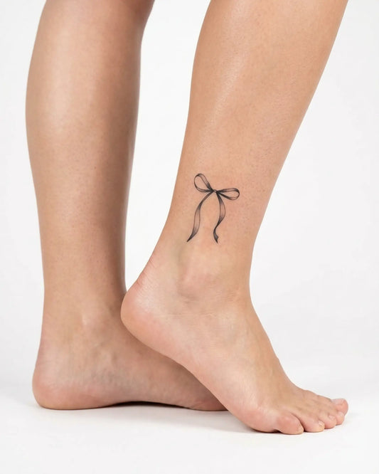 INKY Ribbon Bow semi-permanent tattoo applied on a woman – 2 x 2 in (4x4 cm) design, realistic ink look, lasts 10 days