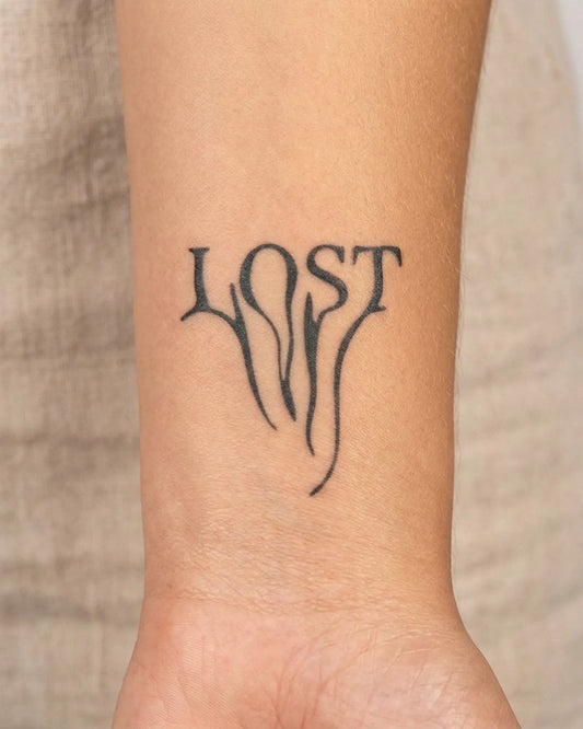 INKY LOST Script semi-permanent tattoo applied on a woman – 2 x 2 in (4x4 cm) design, realistic ink look, lasts 10 days