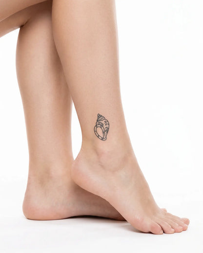 INKY Ocean Shell semi-permanent tattoo applied on a woman – 2 x 2 in (4x4 cm) design, realistic ink look, lasts 10 days