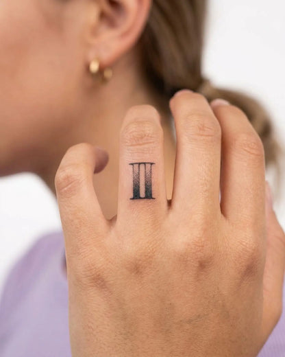 INKY Distressed 2 2 semi-permanent tattoo applied on a woman – 0.5 x 0.5 in (1x1 cm) design, realistic ink look, lasts 10 days