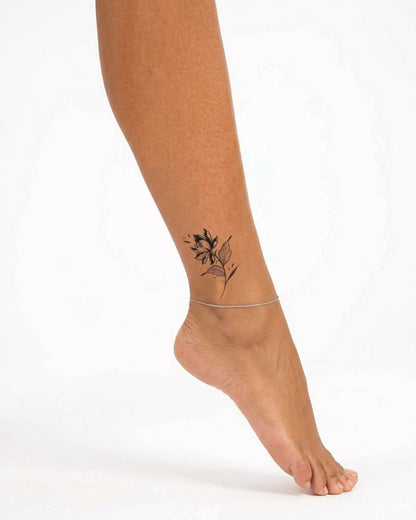 INKY Bloom Noir semi-permanent tattoo applied on a woman – 2 x 2 in (4x4 cm) design, realistic ink look, lasts 10 days