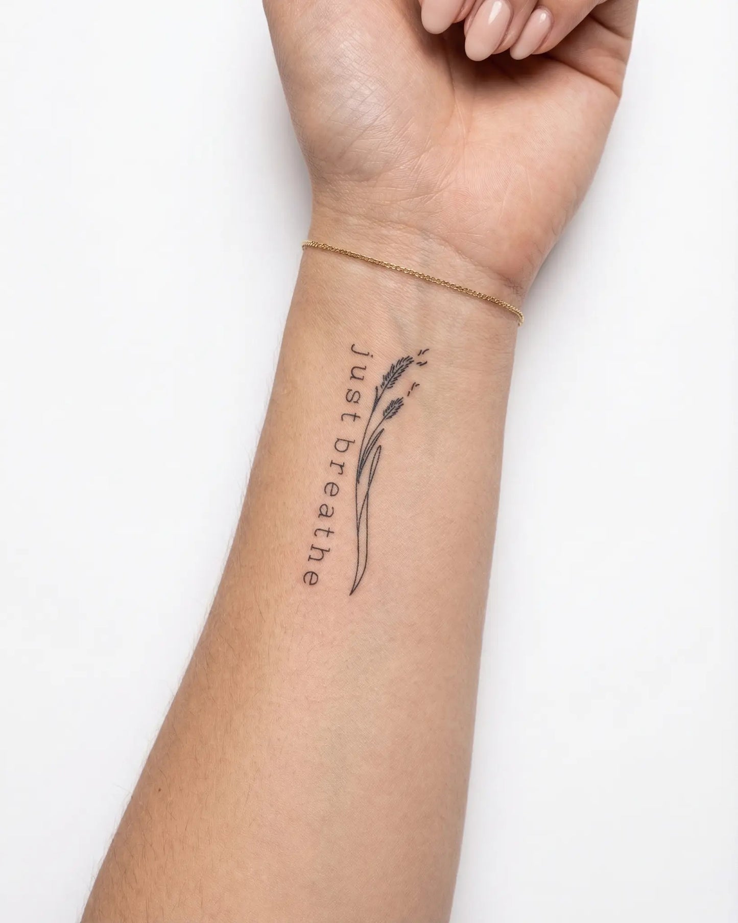 INKY Just Breathe 2 semi-permanent tattoo applied on a woman – 2 x 2 in (4x4 cm) design, realistic ink look, lasts 10 days