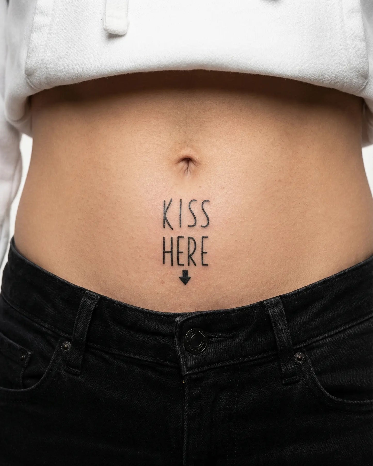 INKY Kiss Here! semi-permanent tattoo applied on a woman – 2 x 2 in (4x4 cm) design, realistic ink look, lasts 10 days