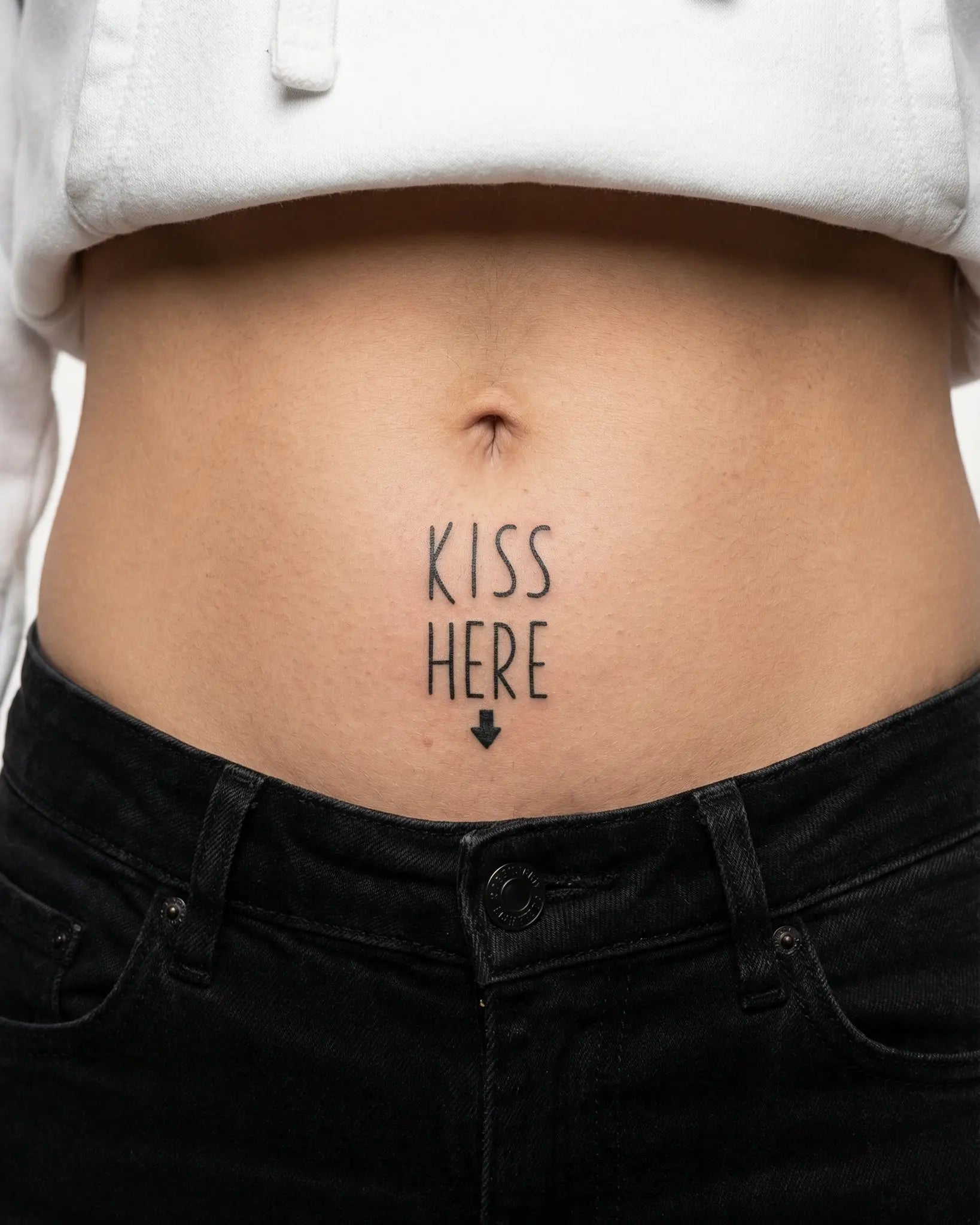 INKY Kiss Here! semi-permanent tattoo applied on a woman – 2 x 2 in (4x4 cm) design, realistic ink look, lasts 10 days