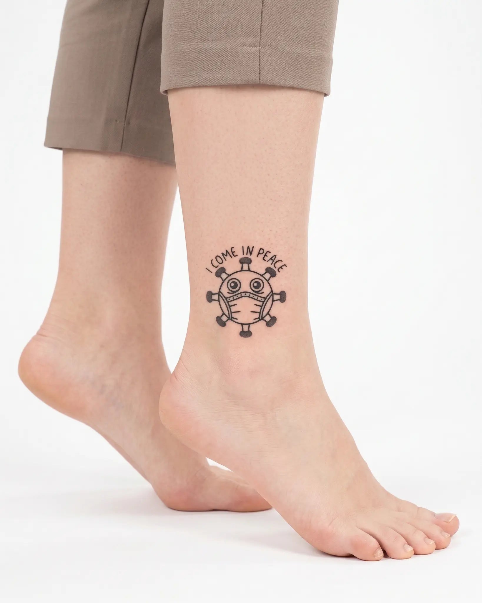 INKY Virus Peace semi-permanent tattoo applied on a woman – 2 x 2 in (4x4 cm) design, realistic ink look, lasts 10 days