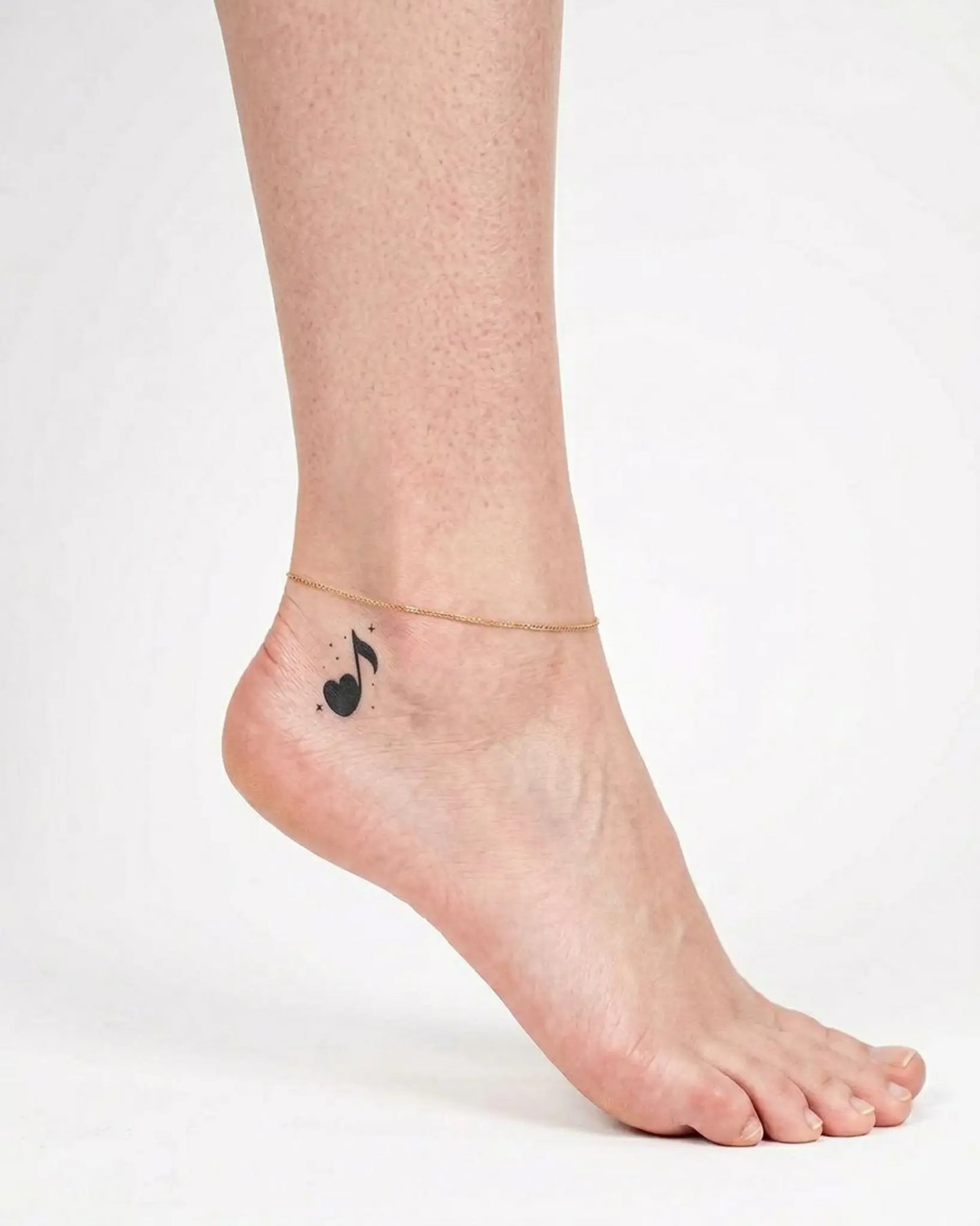 INKY Music Heart semi-permanent tattoo applied on a woman – 2 x 2 in (4x4 cm) design, realistic ink look, lasts 10 days