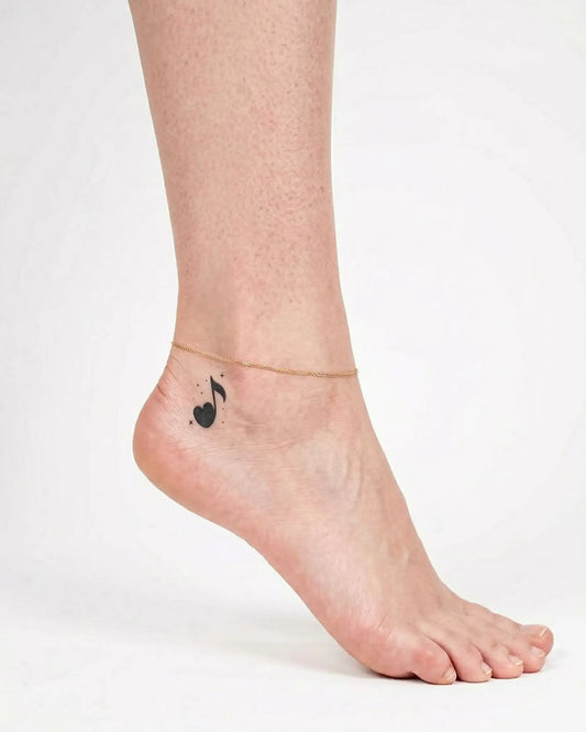 INKY Music Heart semi-permanent tattoo applied on a woman – 2 x 2 in (4x4 cm) design, realistic ink look, lasts 10 days