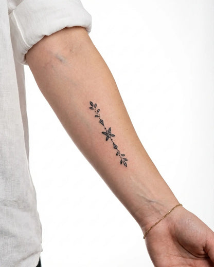 INKY Floral Charm semi-permanent tattoo applied on a woman – 2 x 4 in (6x10 cm) design, realistic ink look, lasts 10 days