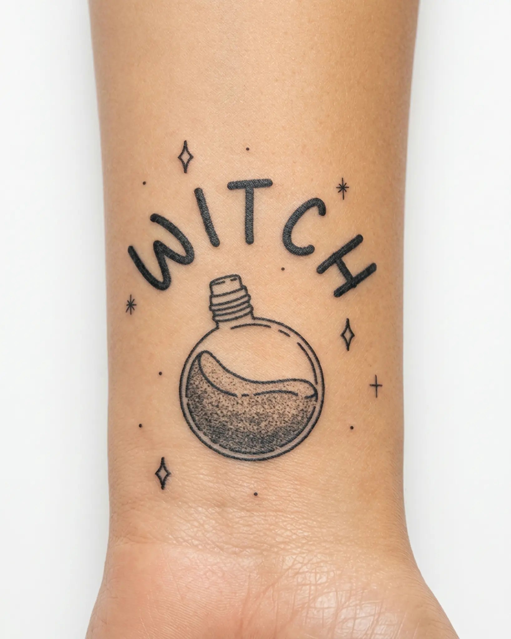 INKY Witch's Brew Potion semi-permanent tattoo applied on a woman – 2 x 2 in (4x4 cm) design, realistic ink look, lasts 10 days