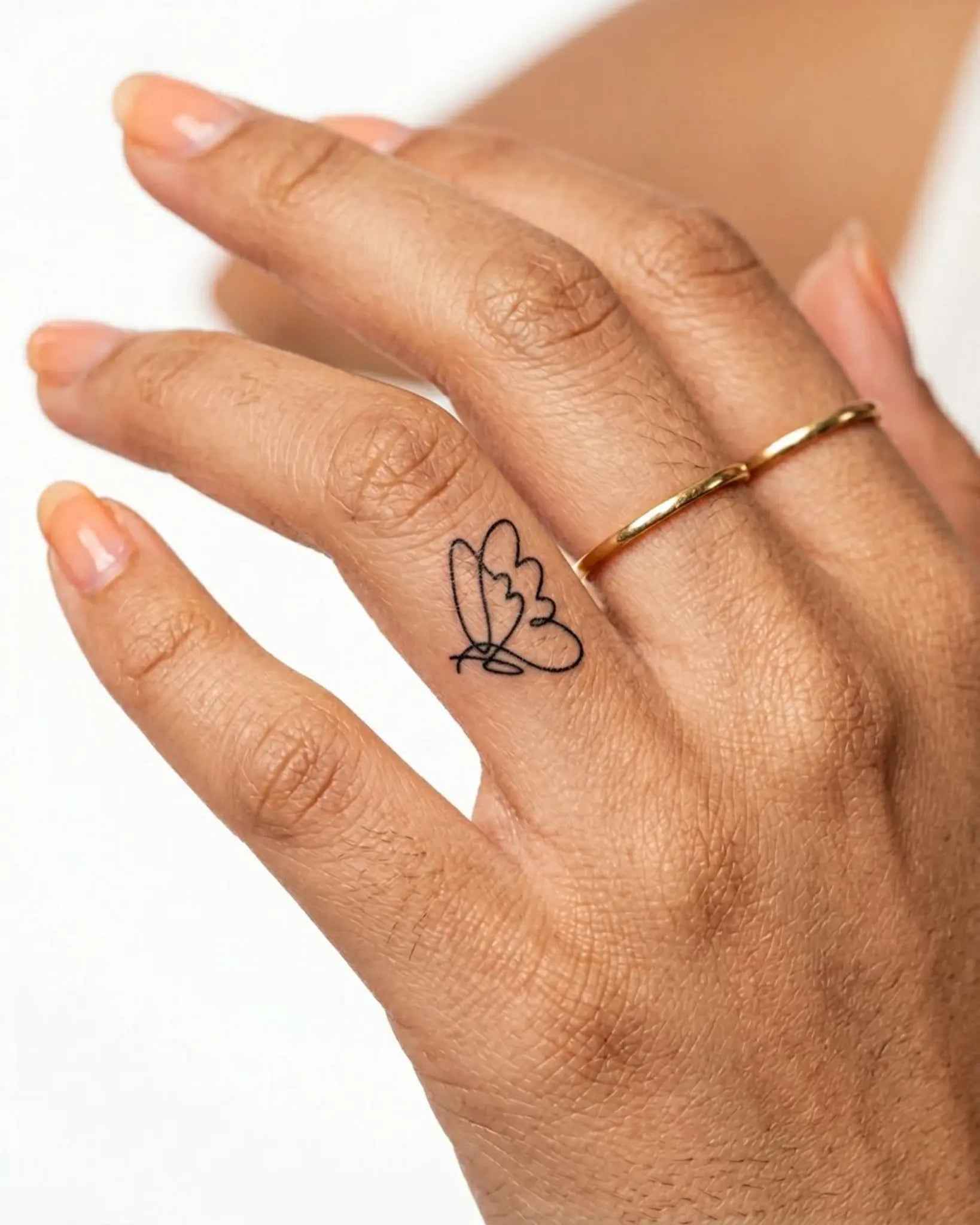 INKY Linefly 2 semi-permanent tattoo applied on a woman – 0.5 x 0.5 in (1x1 cm) design, realistic ink look, lasts 10 days