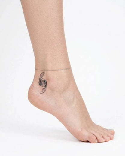 INKY Koi Flow 2 semi-permanent tattoo applied on a woman – 2 x 2 in (4x4 cm) design, realistic ink look, lasts 10 days