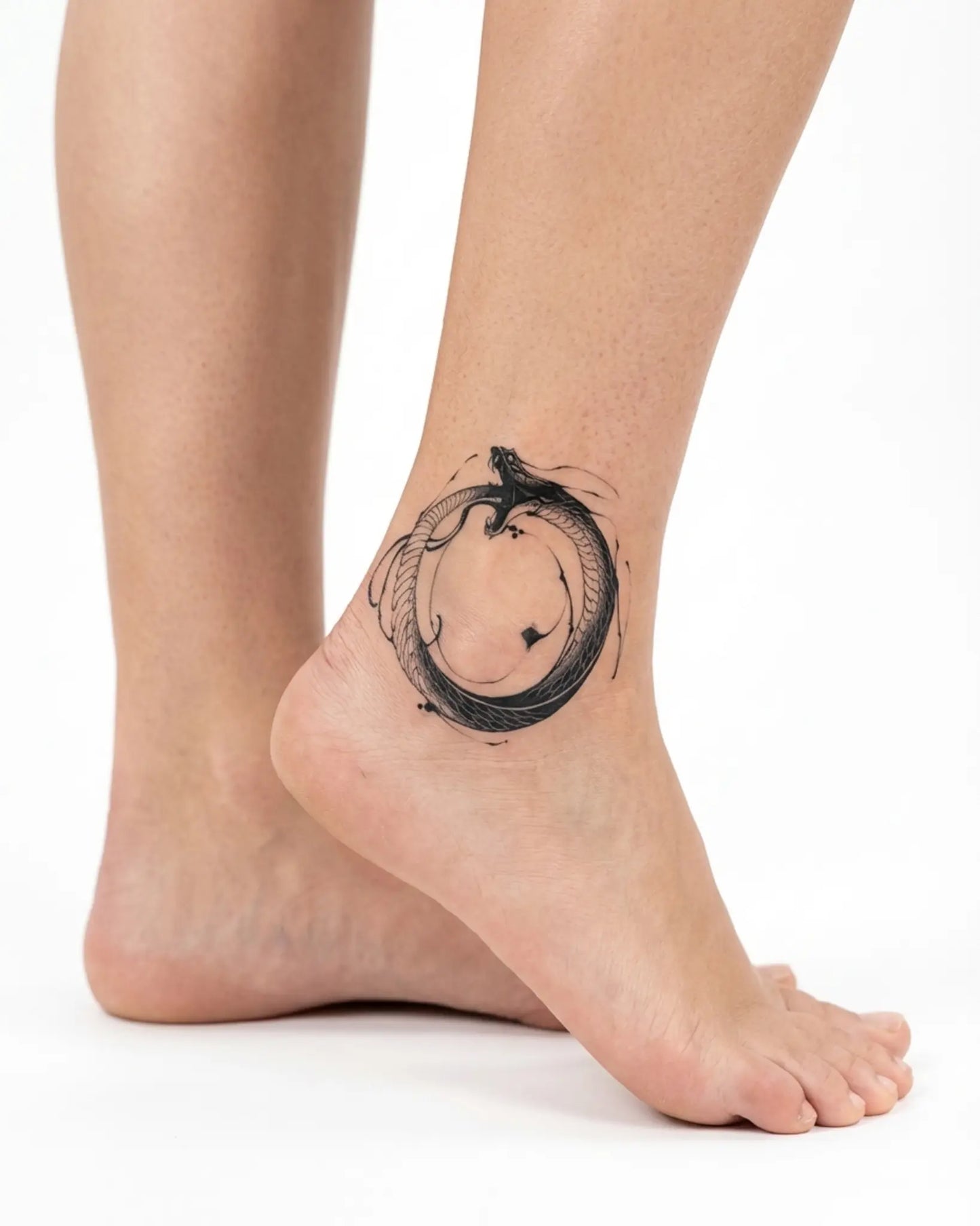 INKY Ouroboros semi-permanent tattoo applied on a woman – 2 x 2 in (4x4 cm) design, realistic ink look, lasts 10 days