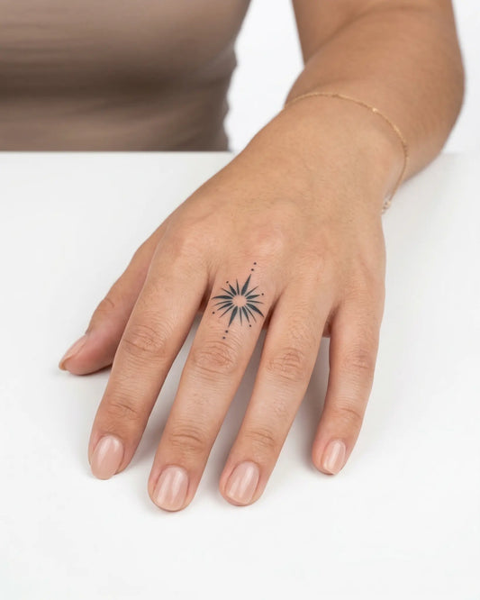 INKY Starburst 2 semi-permanent tattoo applied on a woman – 0.5 x 0.5 in (1x1 cm) design, realistic ink look, lasts 10 days