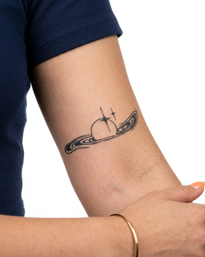 INKY Sparkle Orb semi-permanent tattoo applied on a woman – 2 x 4 in (6x10 cm) design, realistic ink look, lasts 10 days
