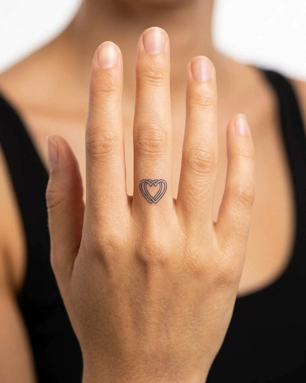 INKY Love Lines semi-permanent tattoo applied on a woman – 0.5 x 0.5 in (1x1 cm) design, realistic ink look, lasts 10 days