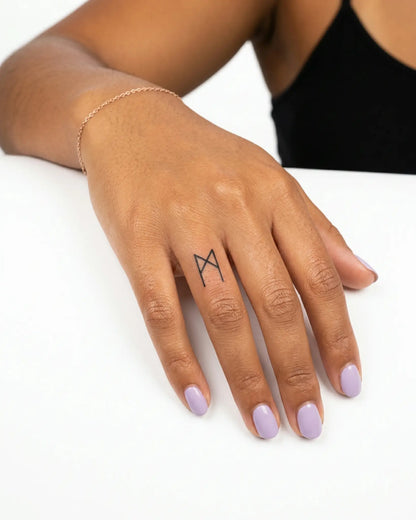 INKY Algiz Rune 3 semi-permanent tattoo applied on a woman – 0.5 x 0.5 in (1x1 cm) design, realistic ink look, lasts 10 days