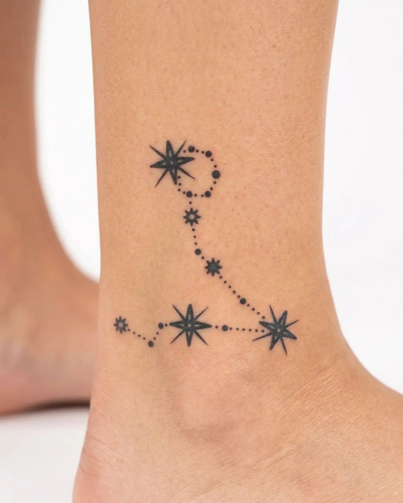 INKY Pisces Star 2 semi-permanent tattoo applied on a woman – 2 x 2 in (4x4 cm) design, realistic ink look, lasts 10 days