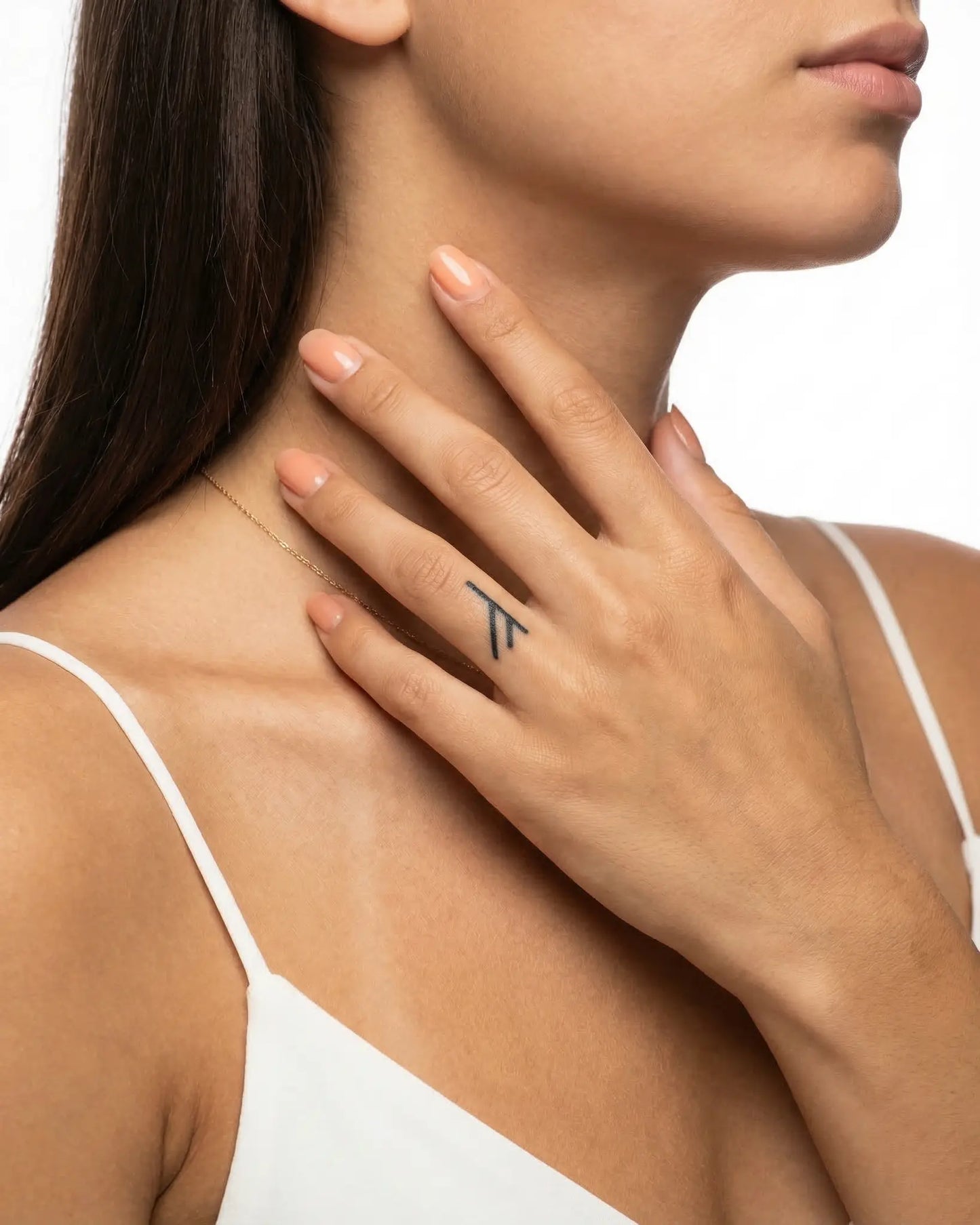 INKY Fehu Rune semi-permanent tattoo applied on a woman – 0.5 x 0.5 in (1x1 cm) design, realistic ink look, lasts 10 days