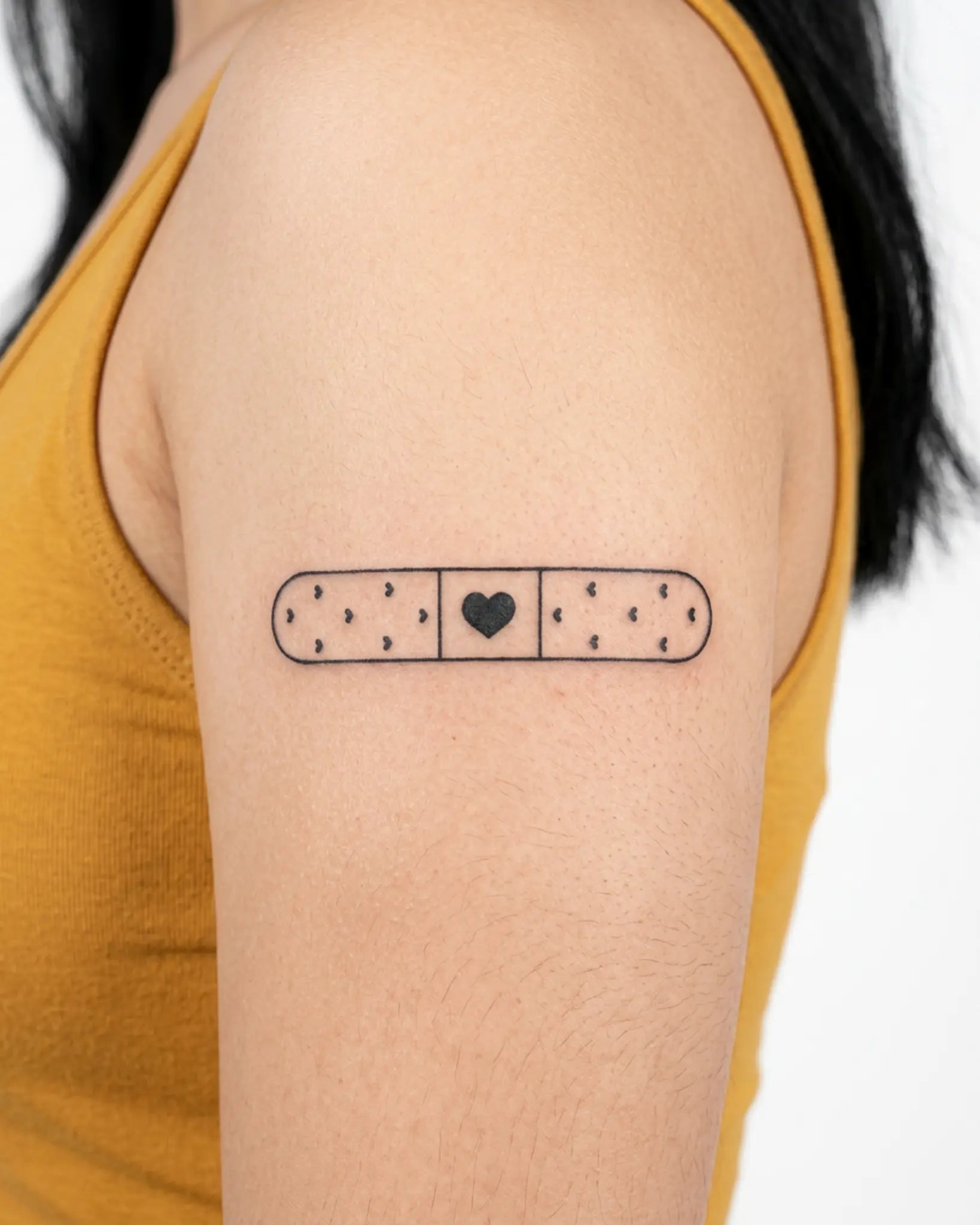 INKY Heart Aid semi-permanent tattoo applied on a woman – 3 x 3 in (7x7 cm) design, realistic ink look, lasts 10 days