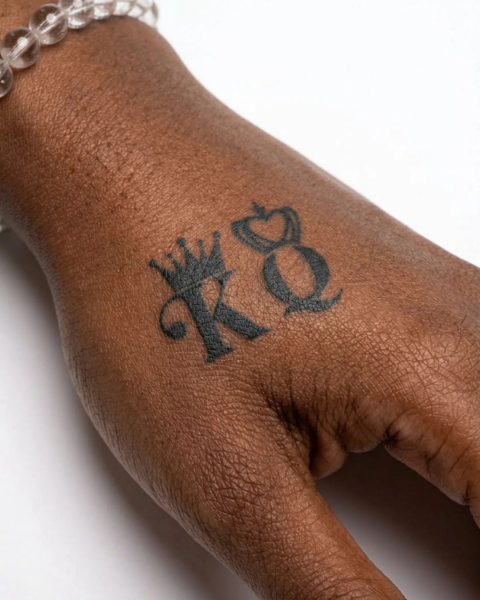 INKY K&Q Crowns semi-permanent tattoo applied on a woman – 2 x 2 in (4x4 cm) design, realistic ink look, lasts 10 days