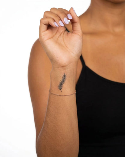 INKY Olive Branch semi-permanent tattoo applied on a woman – 2 x 2 in (4x4 cm) design, realistic ink look, lasts 10 days