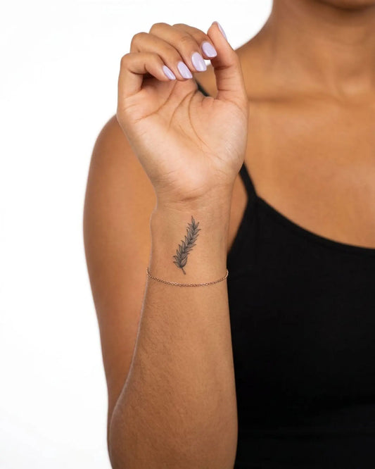 INKY Olive Branch semi-permanent tattoo applied on a woman – 2 x 2 in (4x4 cm) design, realistic ink look, lasts 10 days